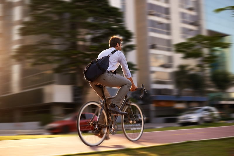 Screenshot of man riding bike to work